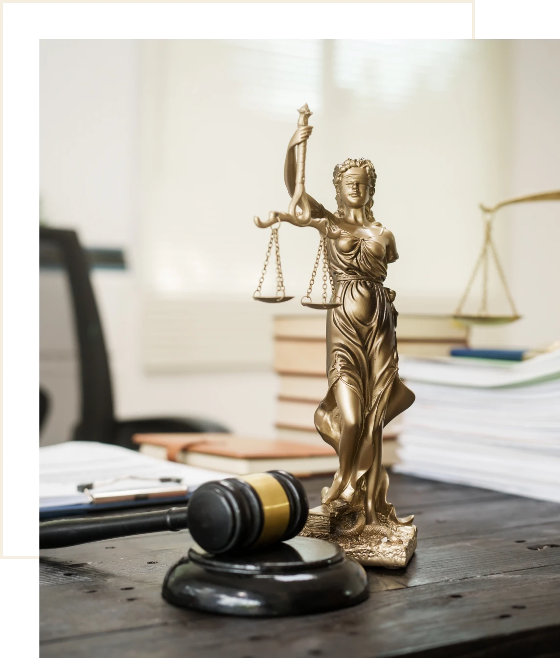 Lady Justice statue with gavel on desk